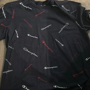 Black Champions tee shirt with the work champion written on the shirt